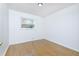 Cozy bedroom with a wood floor, white walls, a window, and wooden trim at 1877 Glenmar Dr, Decatur, GA 30032