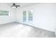 Bedroom with gray carpet, ceiling fan, and French doors at 1877 Glenmar Dr, Decatur, GA 30032