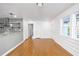 Bright dining area with hardwood floors, shiplap accent wall, and open to the kitchen at 1877 Glenmar Dr, Decatur, GA 30032