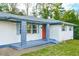 Charming entryway with red door, blue shutters, and gray porch at 1877 Glenmar Dr, Decatur, GA 30032