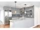 Modern kitchen featuring stainless steel appliances, granite countertops, and floating shelving at 1877 Glenmar Dr, Decatur, GA 30032