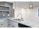 Close-up on kitchen with granite counters, open shelves, and stainless steel appliances at 1877 Glenmar Dr, Decatur, GA 30032