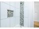 Modern shower with decorative tile inset and shower niche at 1877 Glenmar Dr, Decatur, GA 30032