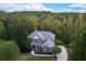 Two-story home amid a lush and private wooded property with gorgeous foliage and mature hardwood trees and landscaping at 203 Glenrise Ct, Woodstock, GA 30188