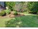 Backyard with lush landscaping and a stepped garden at 203 Glenrise Ct, Woodstock, GA 30188