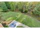 Aerial view of backyard featuring expansive lawn, patio and water feature at 203 Glenrise Ct, Woodstock, GA 30188