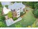 An aerial photo showcases a spacious backyard with a sport court, multi-level deck, and screened-in porch at 203 Glenrise Ct, Woodstock, GA 30188