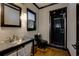 Modern bathroom features a sleek vanity, updated shower and black fixtures at 203 Glenrise Ct, Woodstock, GA 30188