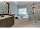 Elegant bathroom with a soaking tub and marble tiled shower at 203 Glenrise Ct, Woodstock, GA 30188