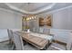 Bright dining room featuring tray ceiling, chandelier, and seating for eight at 203 Glenrise Ct, Woodstock, GA 30188