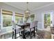 Dining area with a table, four chairs, a pendant light and multiple windows with blinds at 203 Glenrise Ct, Woodstock, GA 30188