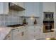 Modern kitchen features gas cooktop, stainless microwave and oven, and white cabinets at 203 Glenrise Ct, Woodstock, GA 30188