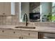 Close up of kitchen with stone backsplash, stainless sink and stainless appliances at 203 Glenrise Ct, Woodstock, GA 30188