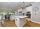 Open-concept kitchen with marble island, white cabinets, and stainless steel appliances at 203 Glenrise Ct, Woodstock, GA 30188