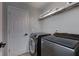 Well-equipped laundry room featuring modern appliances and storage at 203 Glenrise Ct, Woodstock, GA 30188