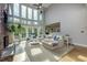 Sun-filled living room featuring a stone fireplace, large windows, and hardwood floors at 203 Glenrise Ct, Woodstock, GA 30188