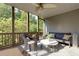 Comfortable screened porch with cushioned seating and wooded views at 203 Glenrise Ct, Woodstock, GA 30188