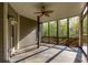 Relaxing screened porch with wood railing and ceiling fan overlooking wooded backyard at 203 Glenrise Ct, Woodstock, GA 30188