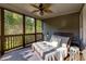 Relax on this screened porch with calming views and a comfortable daybed at 203 Glenrise Ct, Woodstock, GA 30188