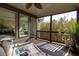 Enjoy outdoor living in this screened porch with views of nature at 203 Glenrise Ct, Woodstock, GA 30188