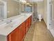 Well-lit bathroom with double vanity, neutral tile flooring and glass-enclosed shower at 3628 Princeton Ave, Atlanta, GA 30337