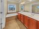 Bathroom with double vanity, soaking tub, and large window at 3628 Princeton Ave, Atlanta, GA 30337