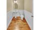 Charming half bathroom featuring white wainscoting, pedestal sink and hardwood floors at 3628 Princeton Ave, Atlanta, GA 30337