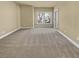 Neutral main bedroom showcasing cozy carpet, neutral paint, and a large window at 3628 Princeton Ave, Atlanta, GA 30337