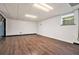 Spacious basement area with window, hardwood flooring, and white walls at 4141 Willow Ridge Rd, Douglasville, GA 30135