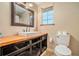 Bathroom featuring wood counter, farmhouse sink, tile flooring, and window at 4141 Willow Ridge Rd, Douglasville, GA 30135