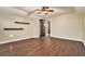 Spacious bedroom with dark wood flooring, two shelves, ceiling fan and neutral walls at 4141 Willow Ridge Rd, Douglasville, GA 30135