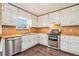 Functional kitchen with white cabinets, stainless steel appliances, and updated countertops at 4141 Willow Ridge Rd, Douglasville, GA 30135