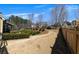 Spacious backyard featuring green bushes and a wooden fence at 112 Bluestone Ct, Acworth, GA 30101
