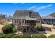 Aerial view of the backyard featuring a deck with outdoor seating and green bushes at 112 Bluestone Ct, Acworth, GA 30101