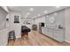 Finished basement area with modern cabinets, granite countertops, and stainless-steel refrigerator at 112 Bluestone Ct, Acworth, GA 30101
