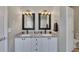 Charming bathroom features double sinks with granite countertops and stylish light fixtures above framed mirrors at 112 Bluestone Ct, Acworth, GA 30101