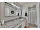 Bathroom features a granite countertop, large mirror and a shower with gray plank flooring at 112 Bluestone Ct, Acworth, GA 30101
