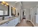 A bathroom featuring double vanity sinks with granite countertops, white cabinetry and a glass enclosed shower at 112 Bluestone Ct, Acworth, GA 30101
