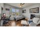 This bedroom includes a ceiling fan, hardwood floors, and a comfortable sitting area at 112 Bluestone Ct, Acworth, GA 30101