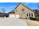 Side view of a two story home with a two car garage and concrete driveway at 112 Bluestone Ct, Acworth, GA 30101