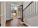 Bright foyer features hardwood floors, a staircase, and a glimpse of the outdoors through the front door at 112 Bluestone Ct, Acworth, GA 30101