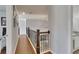 Upstairs hallway featuring hardwood floors, decorative pictures and iron railing at 112 Bluestone Ct, Acworth, GA 30101
