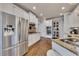 Modern kitchen with stainless steel refrigerator, granite countertops, and white cabinetry at 112 Bluestone Ct, Acworth, GA 30101