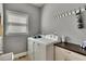 Functional laundry room with gray walls and white appliances, offering a practical space for laundry tasks at 112 Bluestone Ct, Acworth, GA 30101