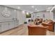Basement living room featuring modern fireplace, light wood floors and gray cabinets at 112 Bluestone Ct, Acworth, GA 30101