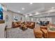 Spacious basement living room with ample seating, light wood floors, fireplace and large TV at 112 Bluestone Ct, Acworth, GA 30101