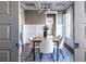 Dining room with modern chandelier, wainscoting, and views to the kitchen and a doorway at 303 Bass Se St, Atlanta, GA 30315