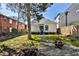 Open backyard includes grassy yard, tree, gravel area with fire pit, and home exterior at 32 Howell Se St, Atlanta, GA 30312
