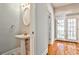 Charming half-bathroom with a pedestal sink and stylish fixtures, conveniently located near the entrance at 32 Howell Se St, Atlanta, GA 30312