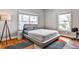 Cozy bedroom with ample natural light, hardwood floors, and a comfortable bed, ideal for relaxation at 32 Howell Se St, Atlanta, GA 30312